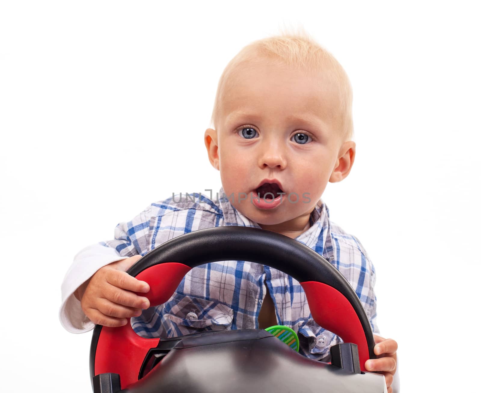 Little boy holding a toy steering wheel over white by photobac
