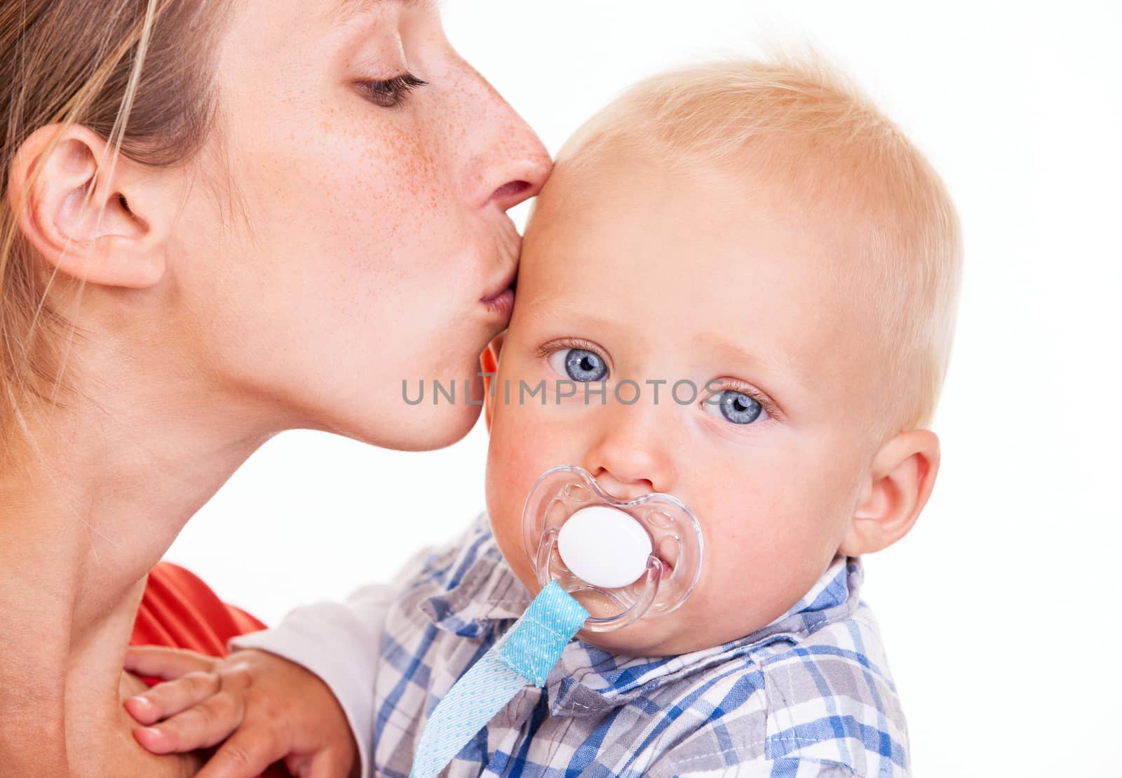 Young Caucasian woman kissing her baby son over white, closeup view