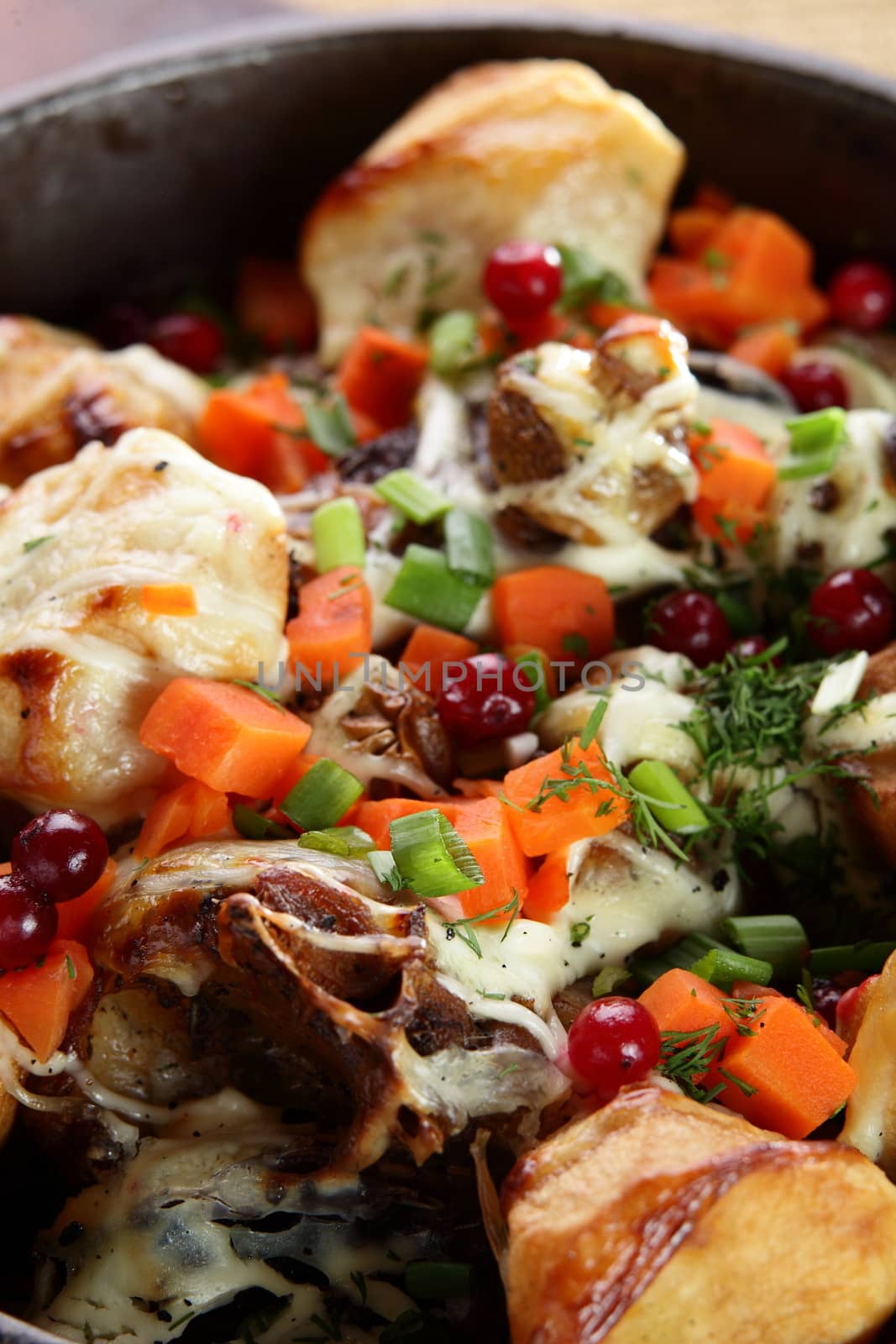 roasted potatoe with mushrooms on hot black pan