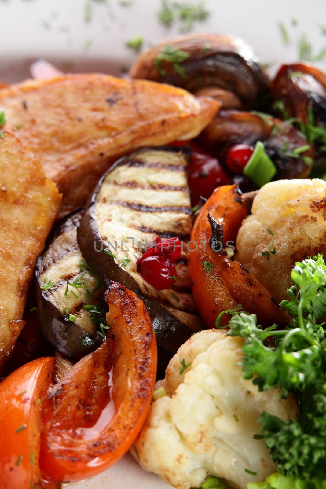 roated meat with mushrooms and vegetables on white dish