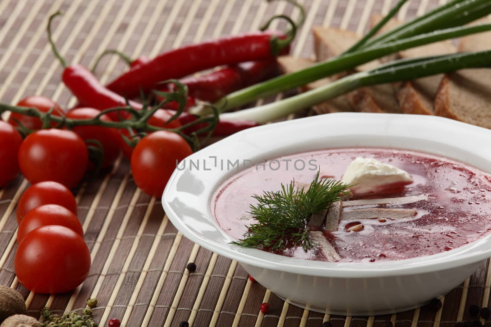 Cold and fresh soup with meat on the wooden table