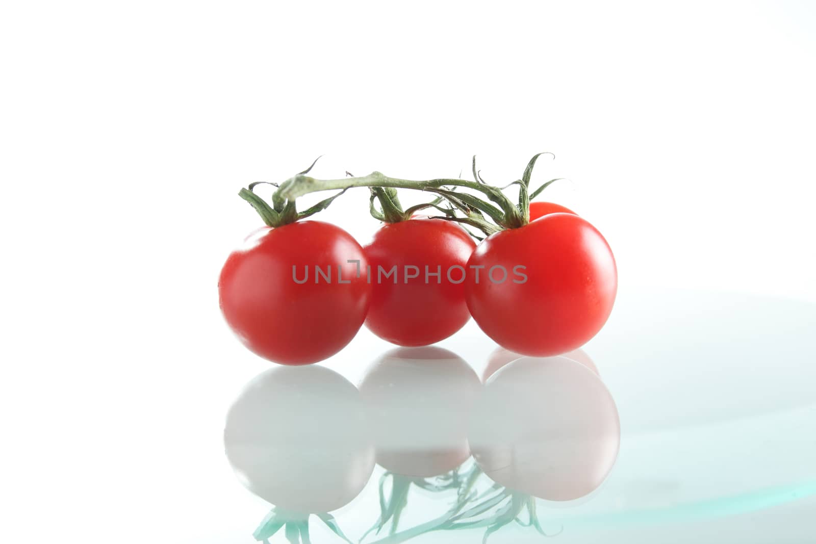 three fresh tomatoes by fiphoto