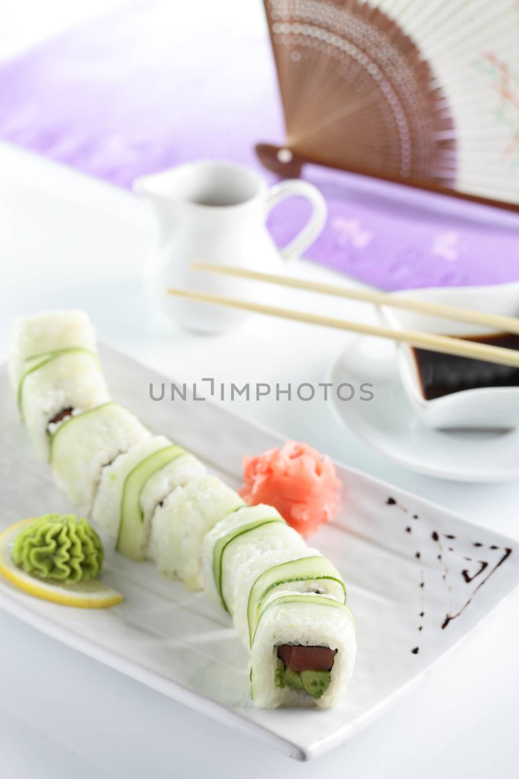 fresh and tasty sushi on bright background