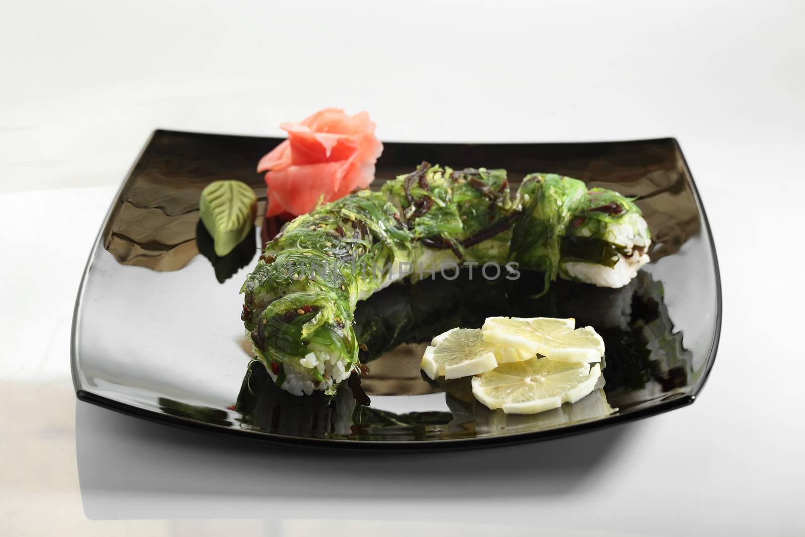 fresh and tasty sushi in black dish by fiphoto