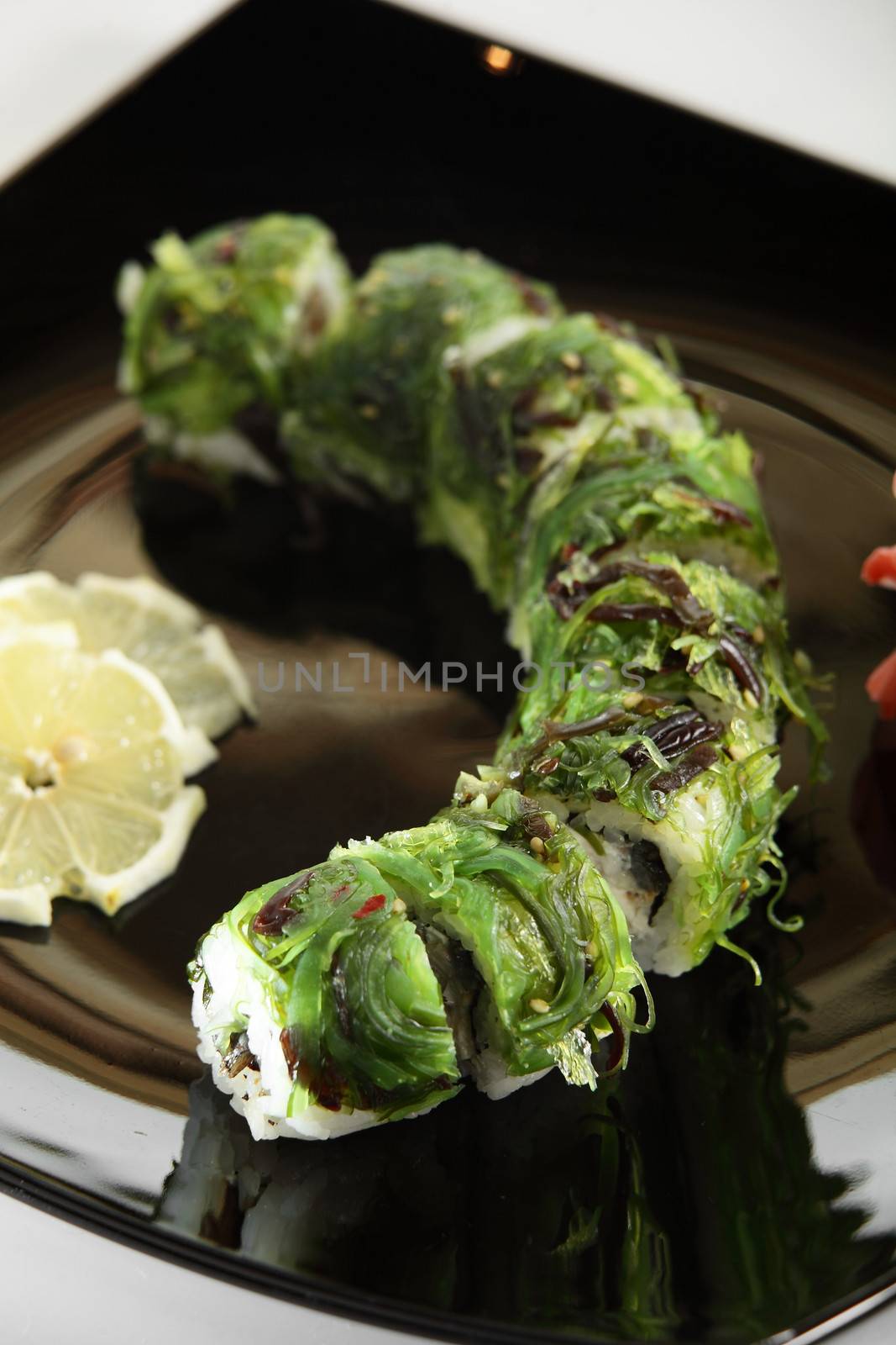 cold sushi on black dish and white background