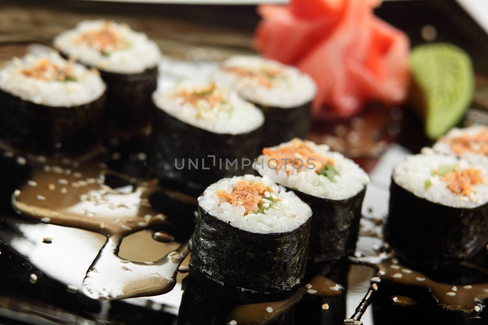 fresh and tasty sushi in black dish by fiphoto
