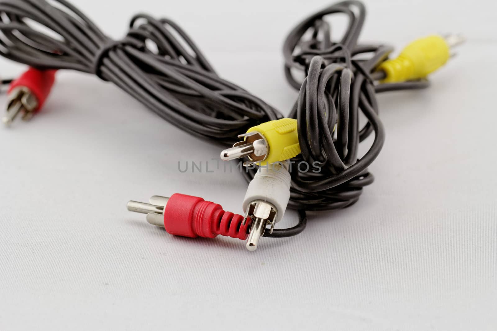 three audio (left - right) - video RCA cable and plug (red, white, yellow) on white background