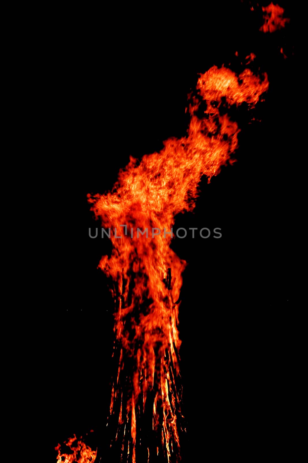 red flames of huge bonfire or campfire as black backgorund