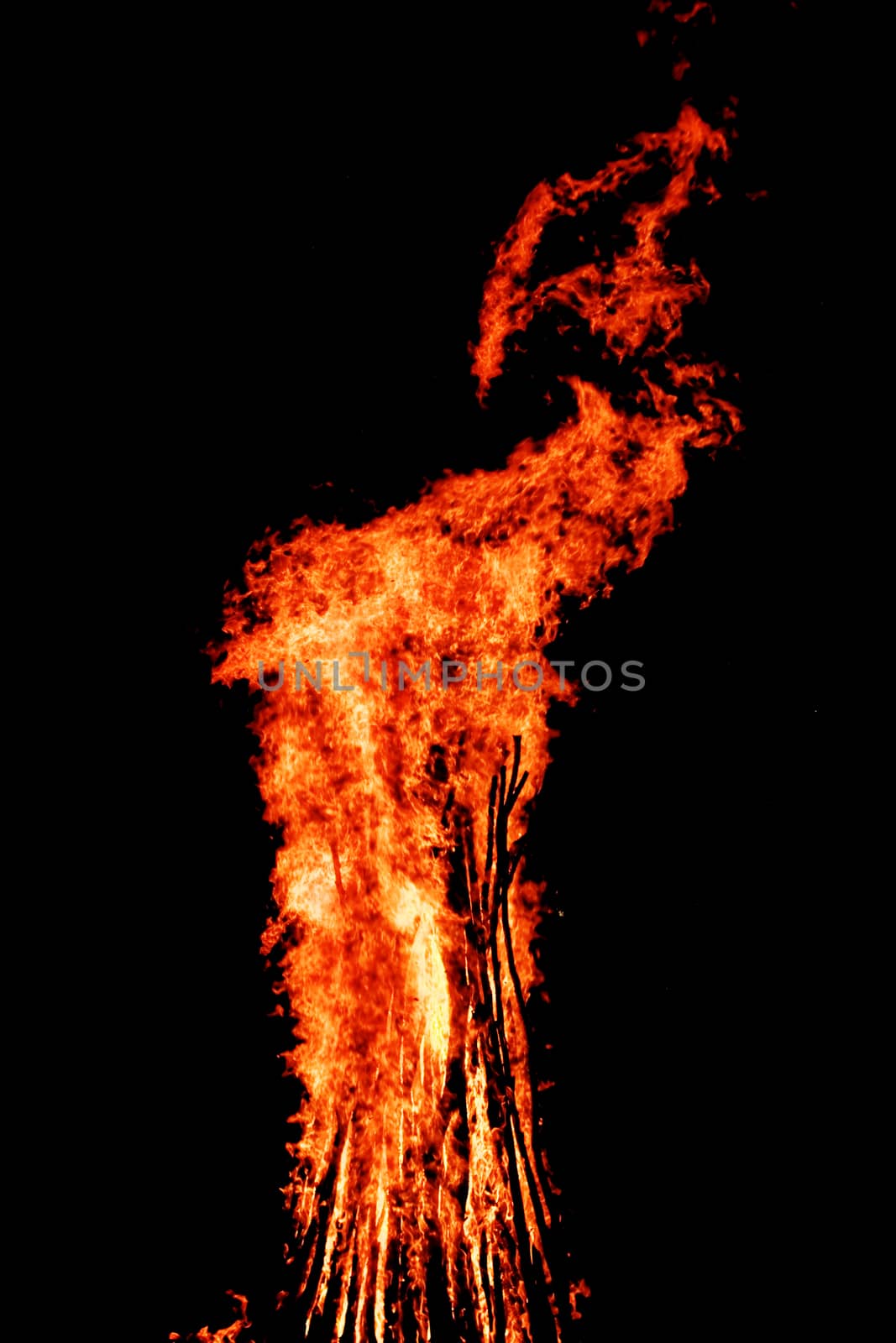 red flames of huge bonfire or campfire as black backgorund