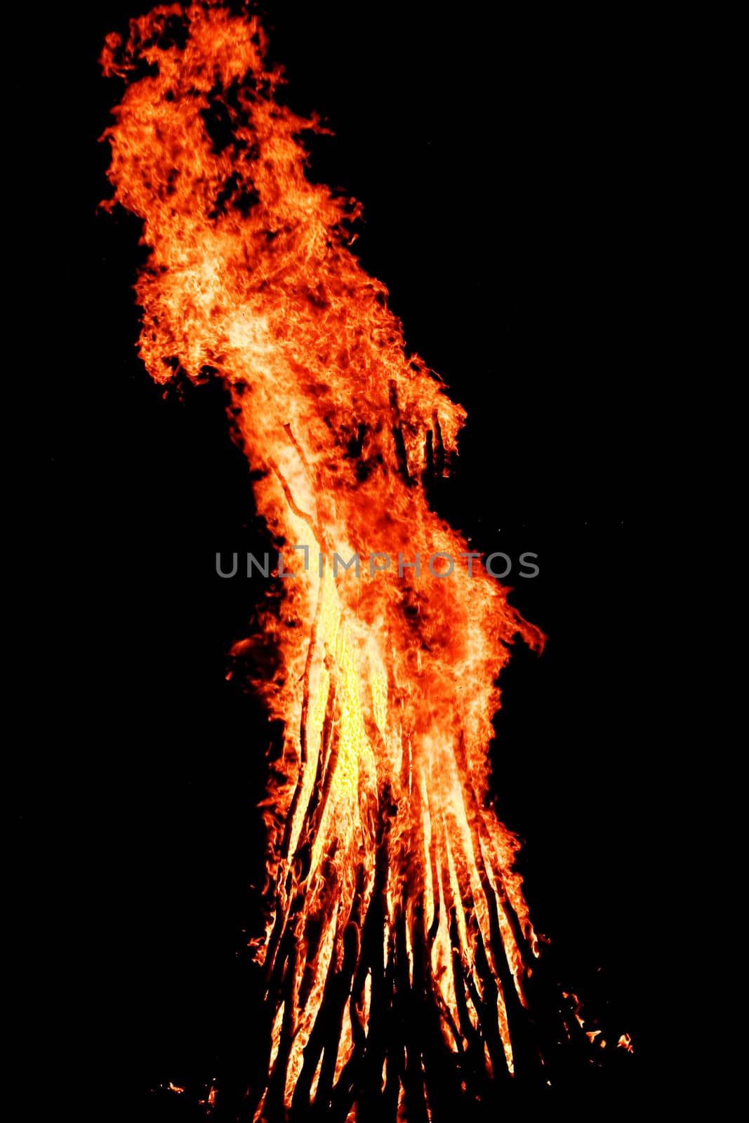 red flames of huge bonfire or campfire as black backgorund