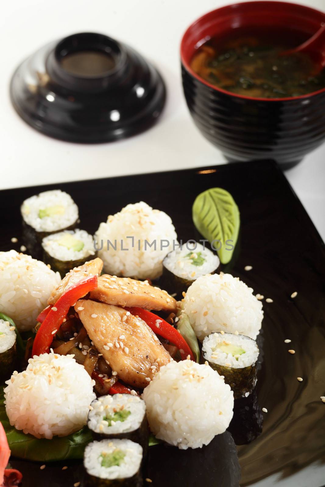 cold sushi on black dish and white background