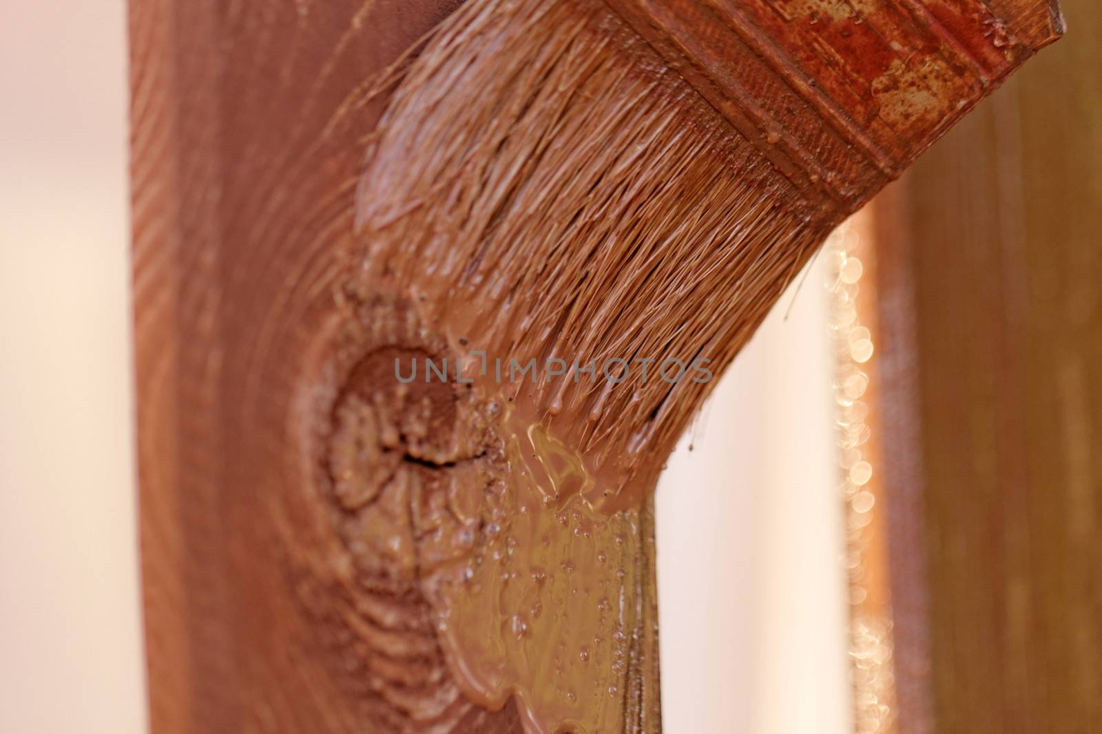 planks fence dyeing with brown paint and brush