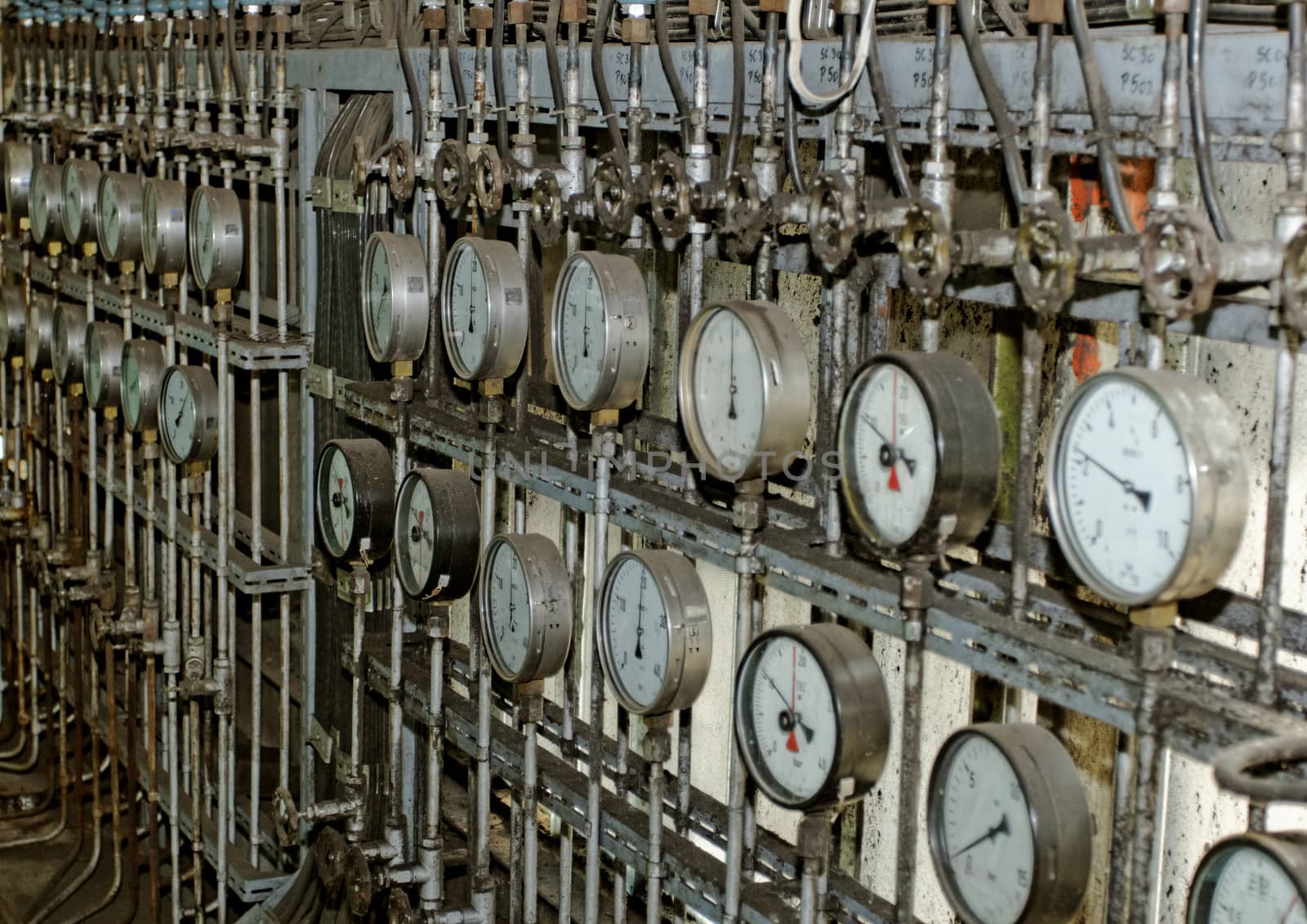 industrial steam pipes in a electricity power plant with pressure meter