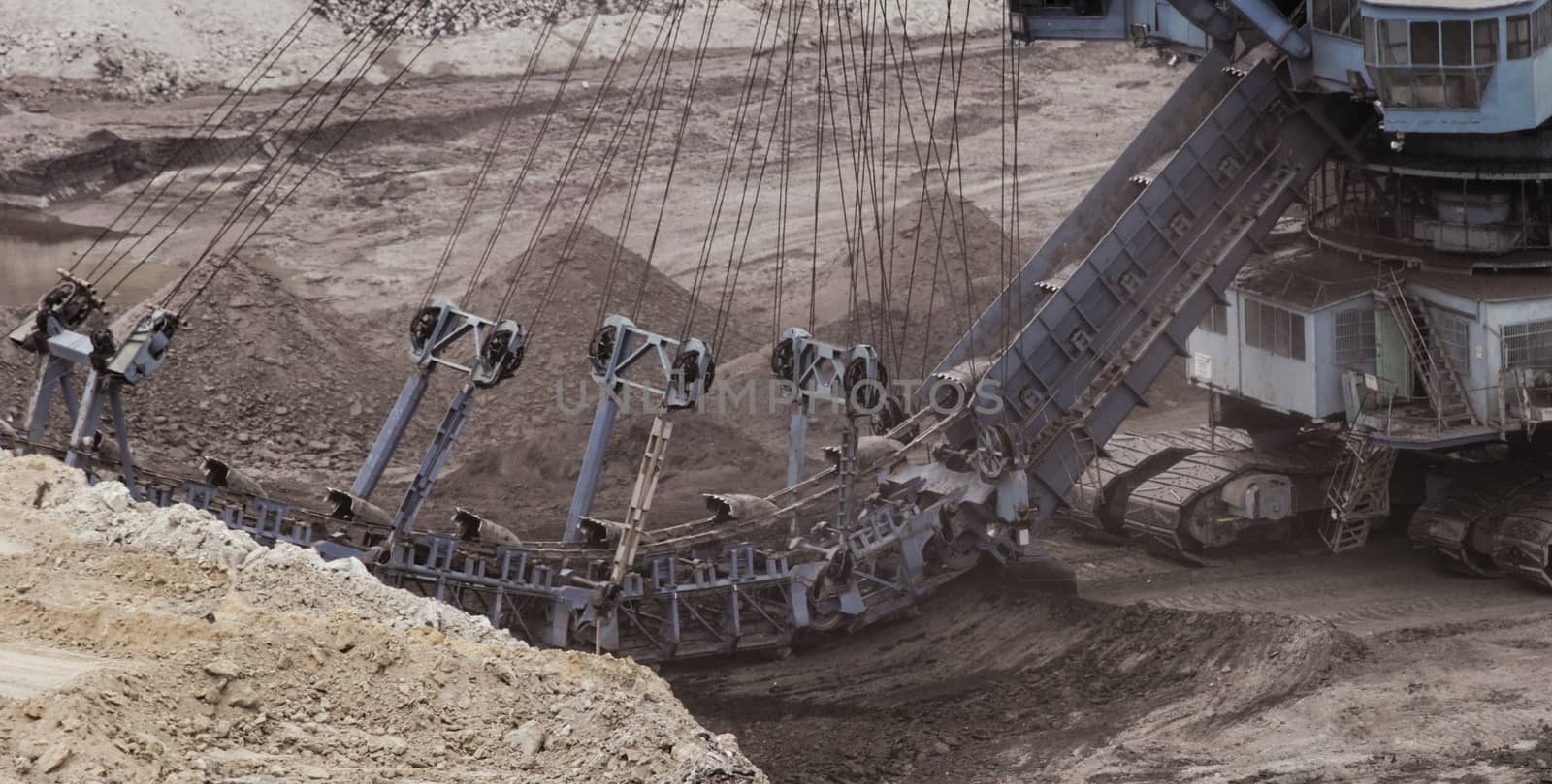 Coal mining in an open pit with huge industrial machine