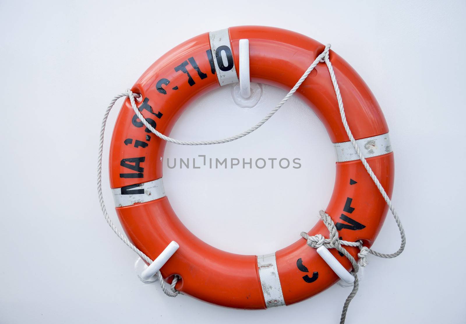 Life vest on white wall by gjeerawut