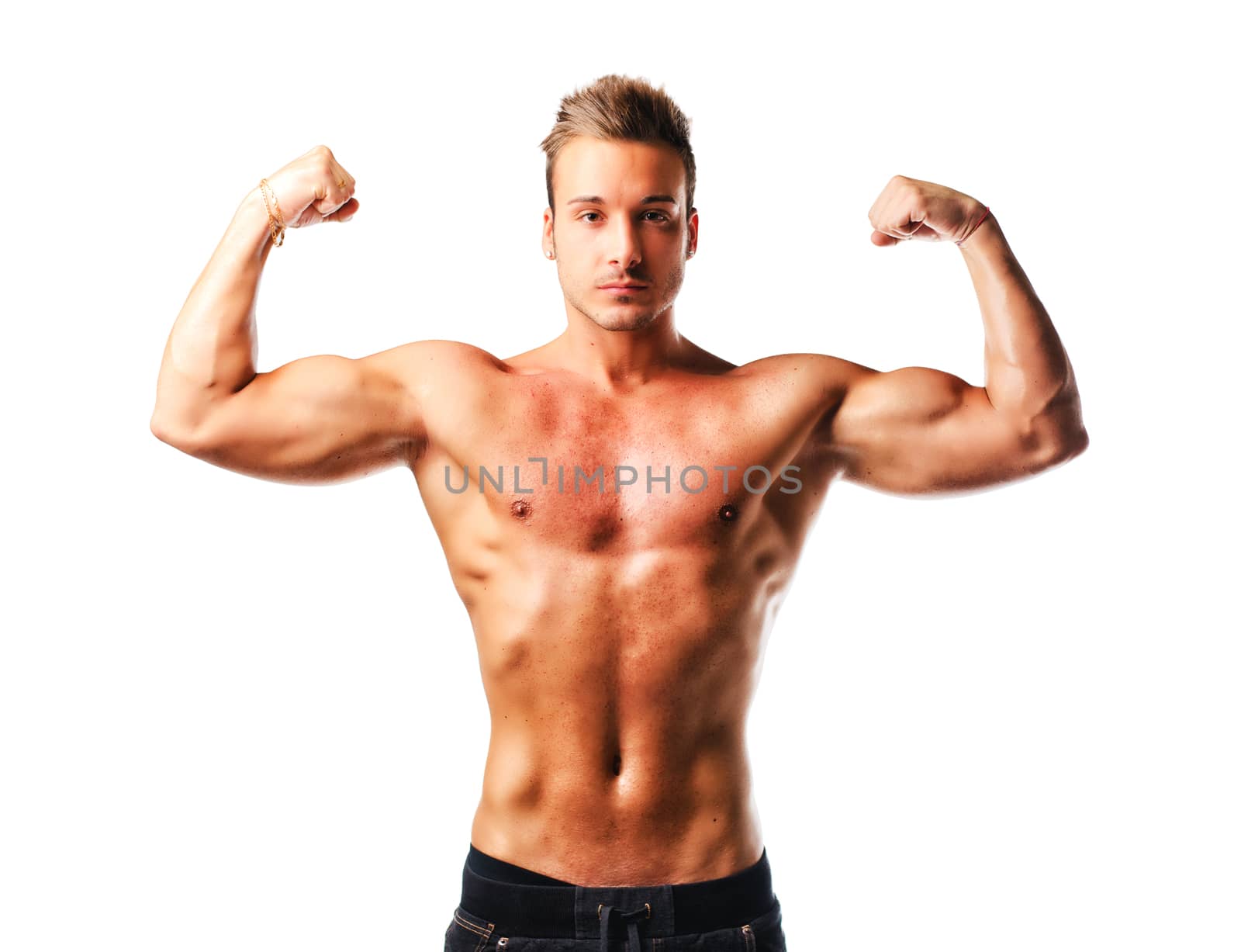 Attractive young muscular man standing naked posing, double biceps pose, isolated