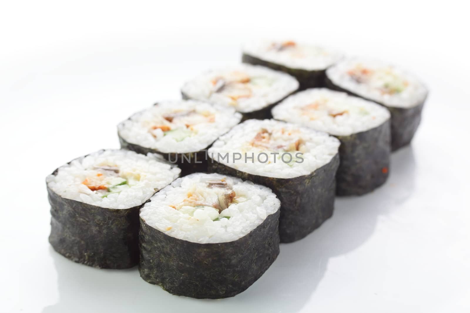 fresh and tasty sushi on white reflective background