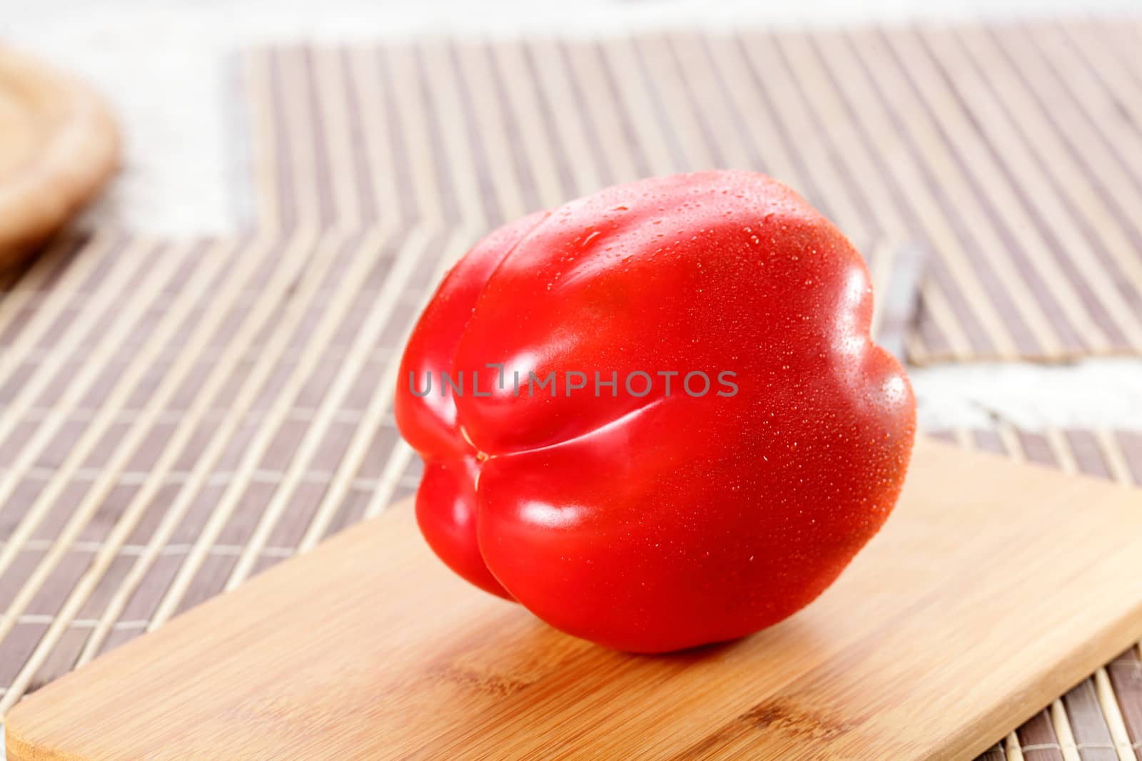 fresh tasty and wet pepper on wooden background