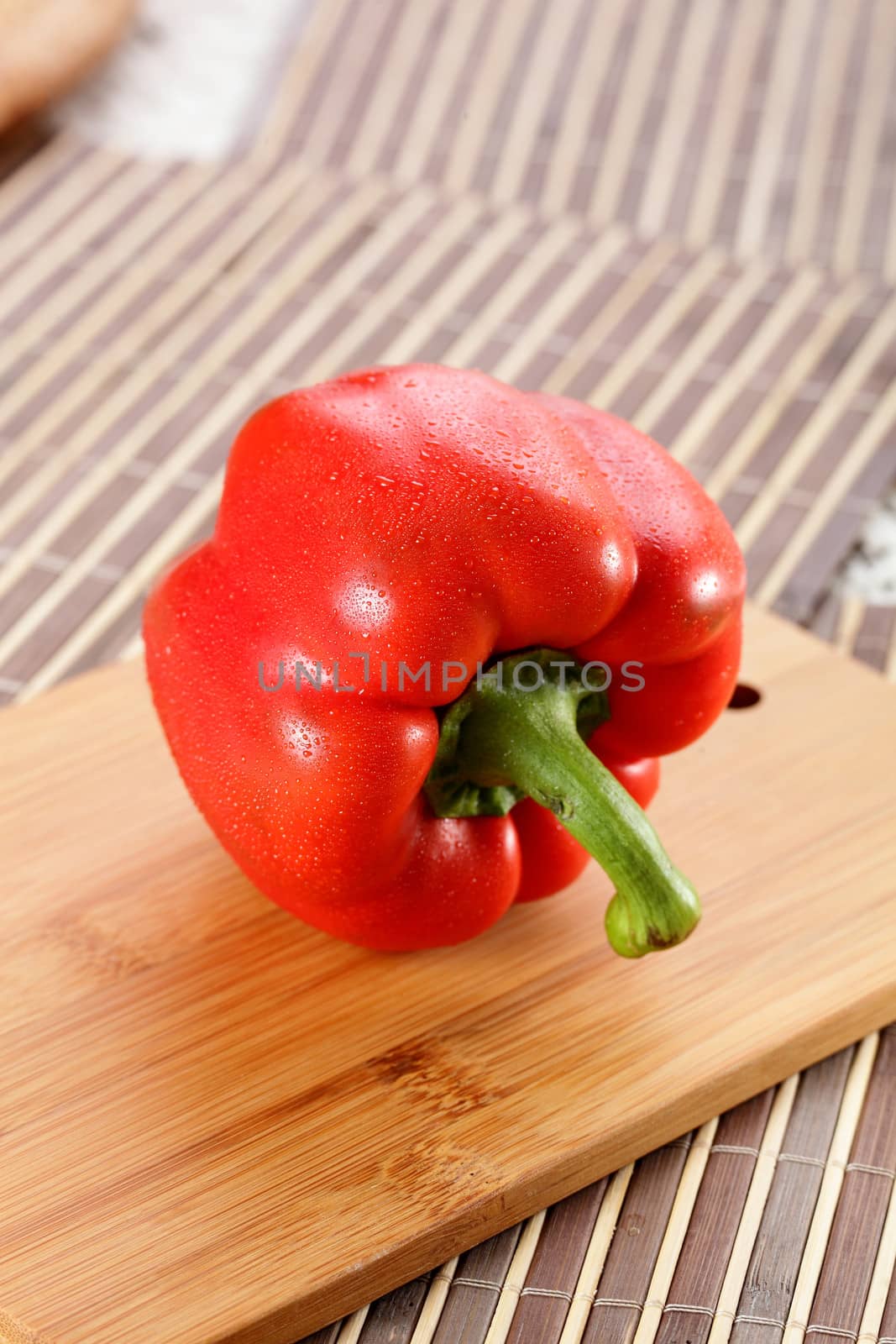 fresh tasty and wet pepper on wooden background