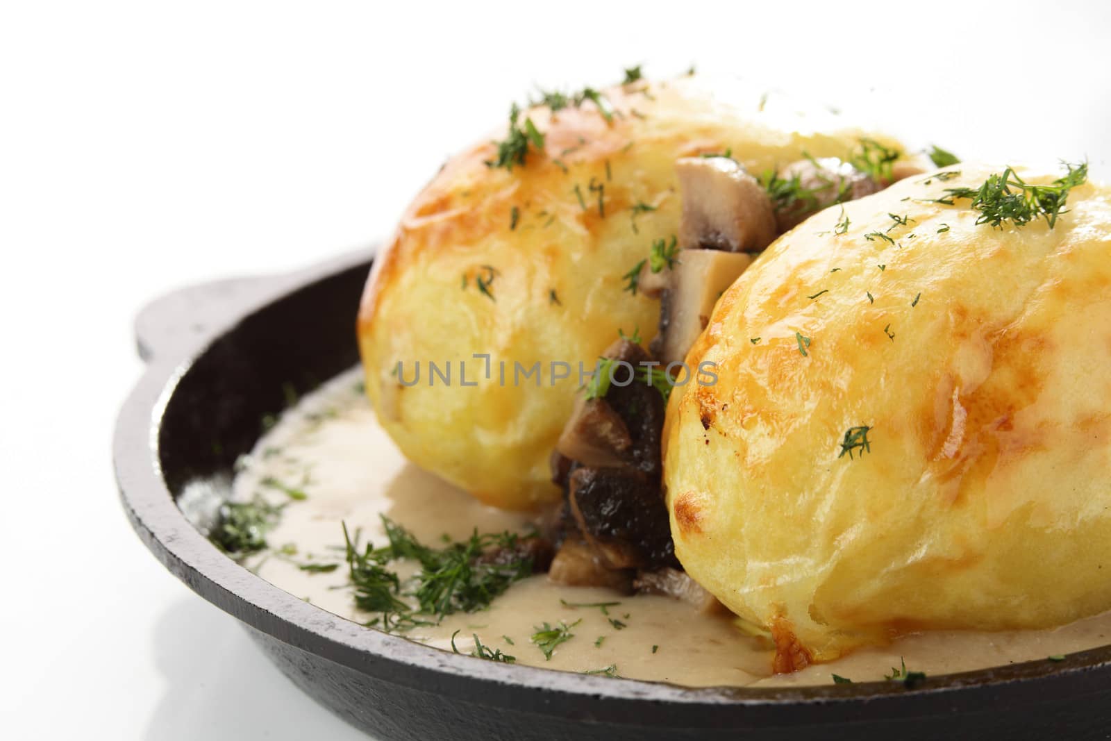 hot roasted potato with mushrooms on white background