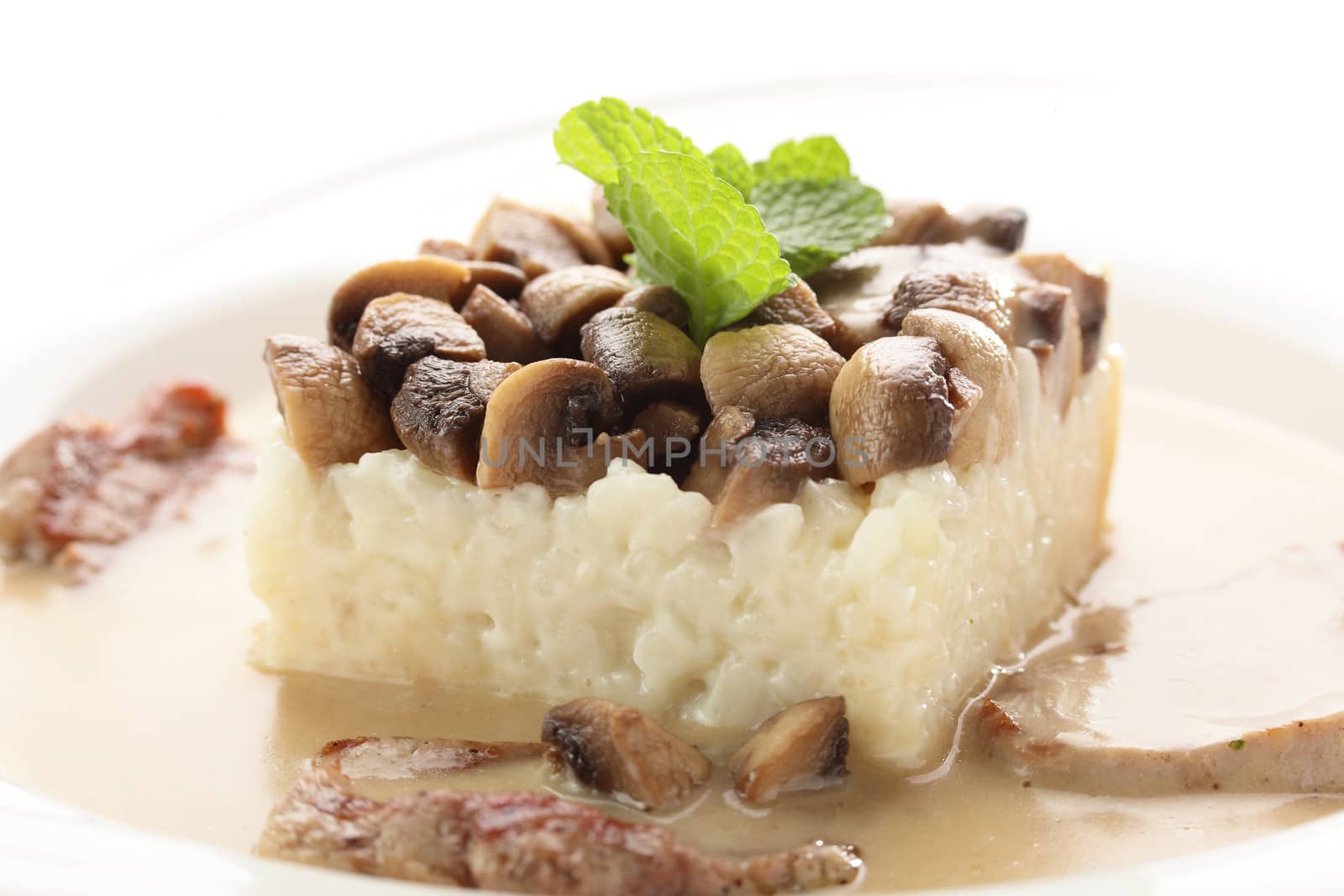 hot roasted meat with rice and mushrooms on white background