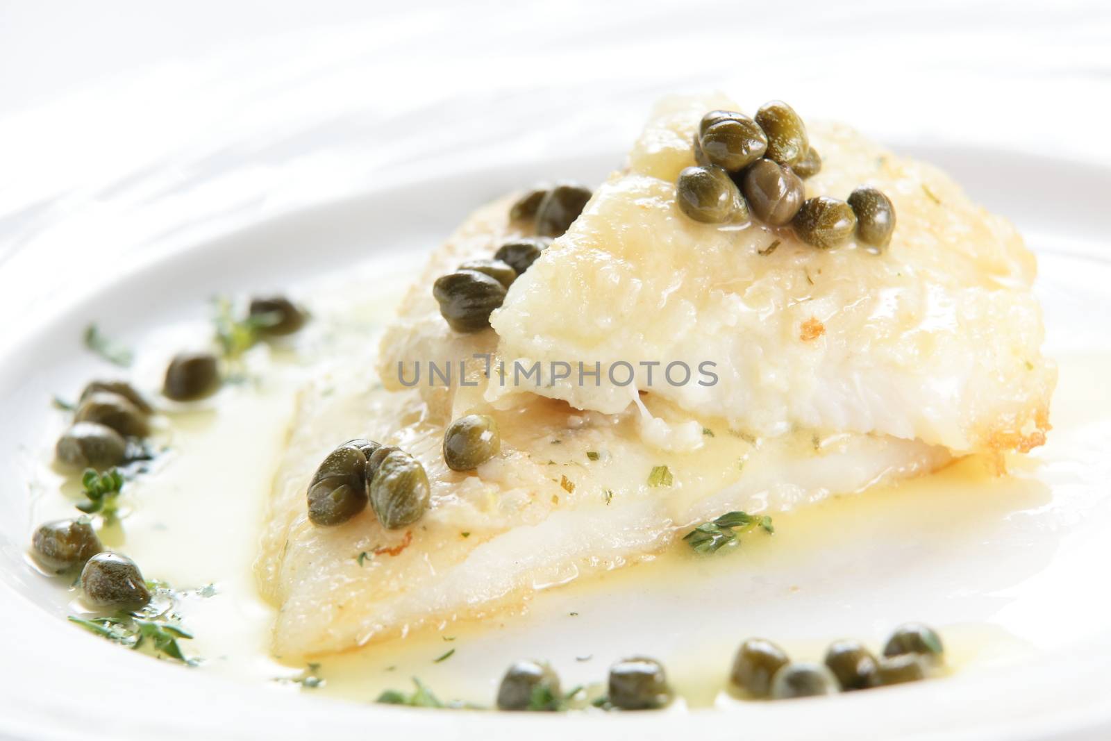 roasted peaces of fish with garnish on white background