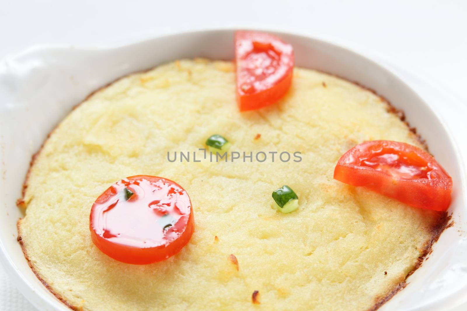 cold roasted potato with tomatoes on white dish