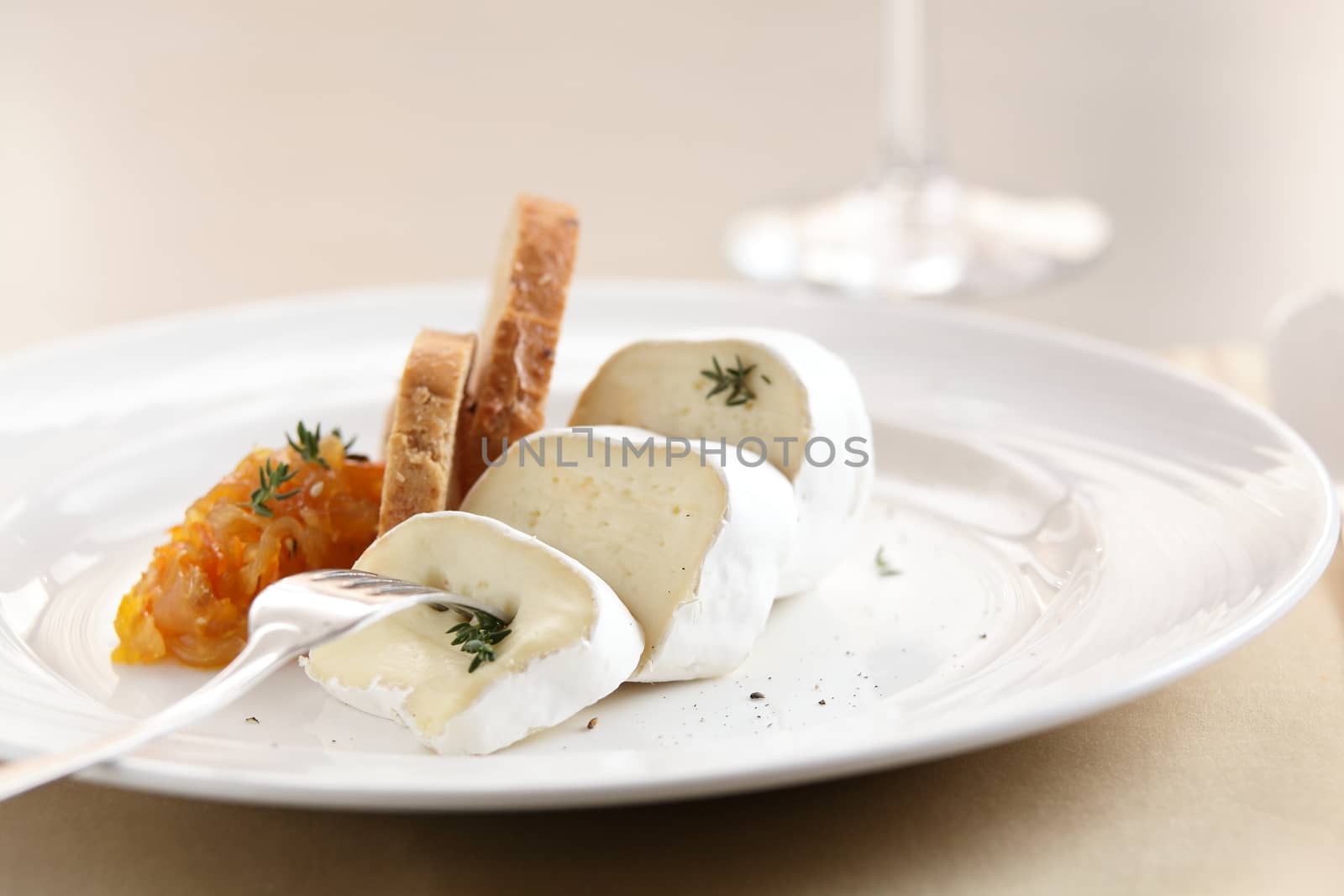 peaces of cheese on white dish by fiphoto