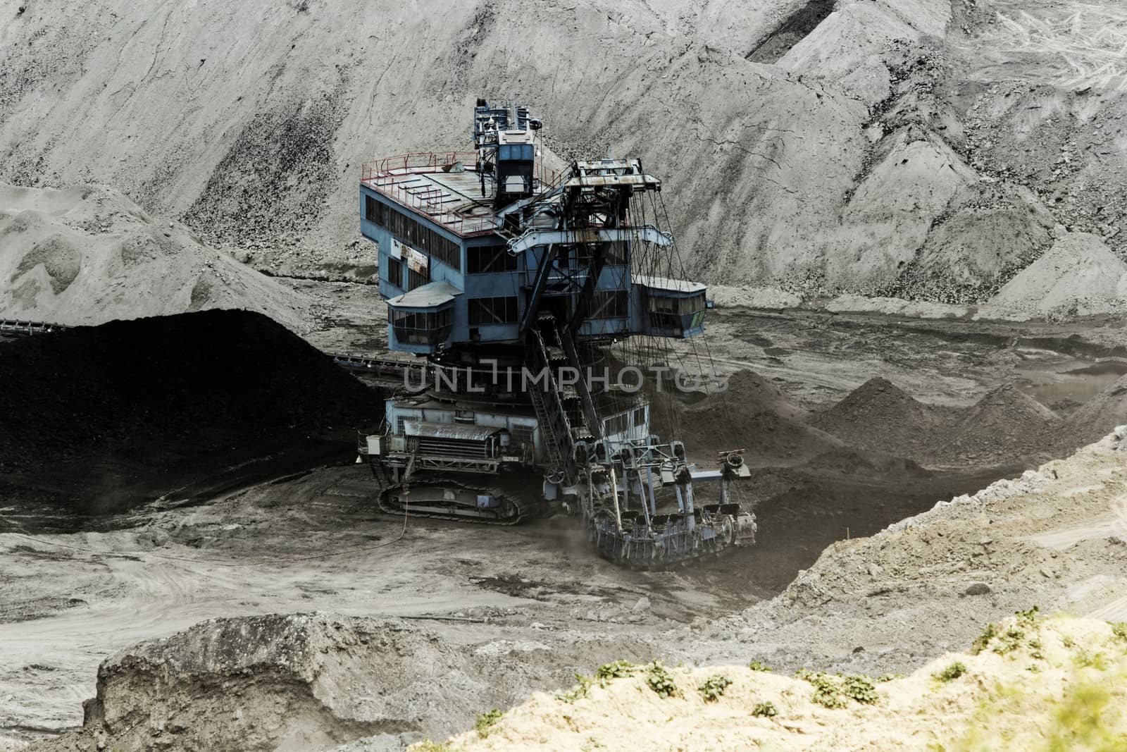 Coal mining in an open pit with huge industrial machine