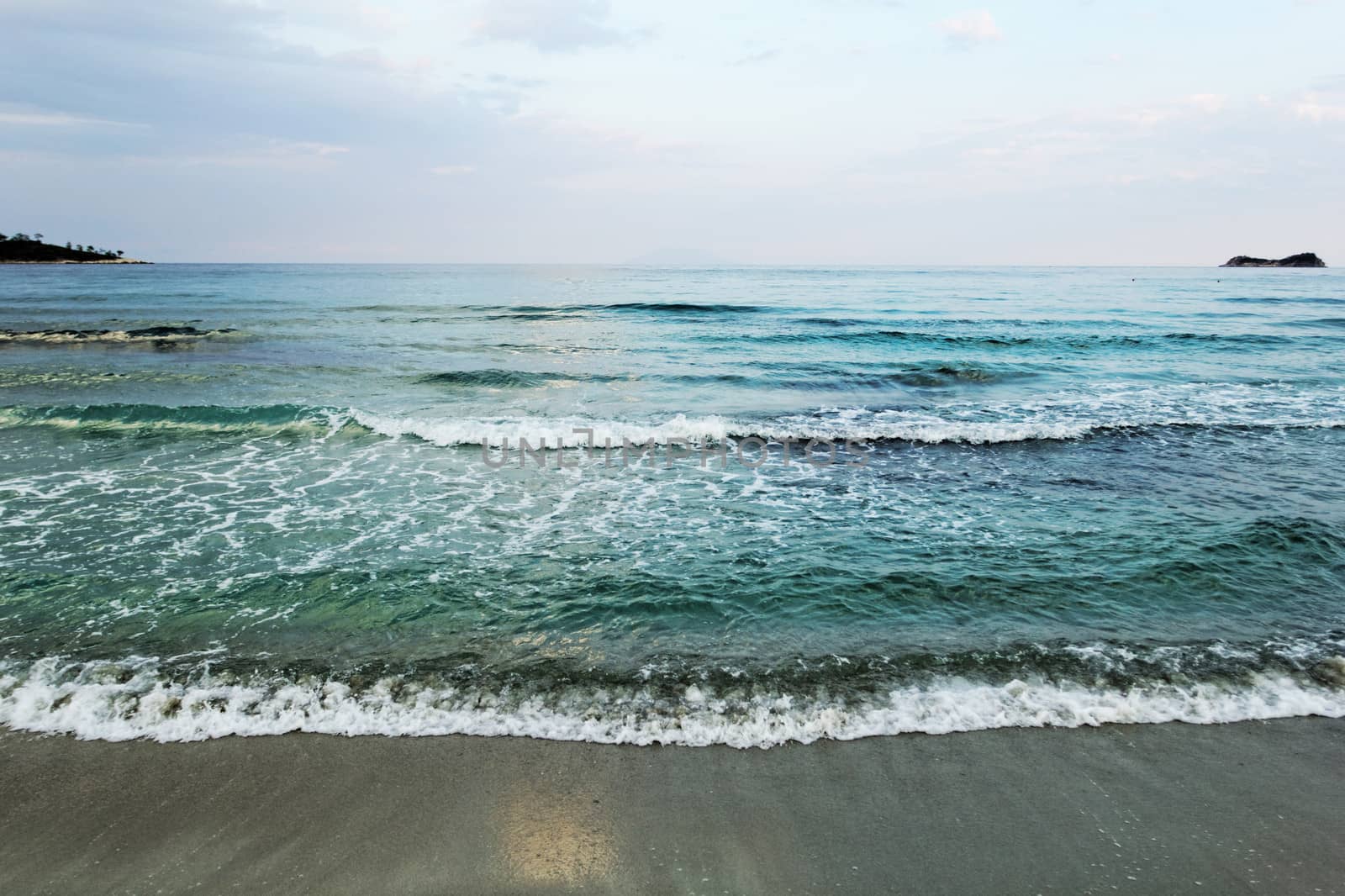 waves of sea on the sandy beach by NagyDodo