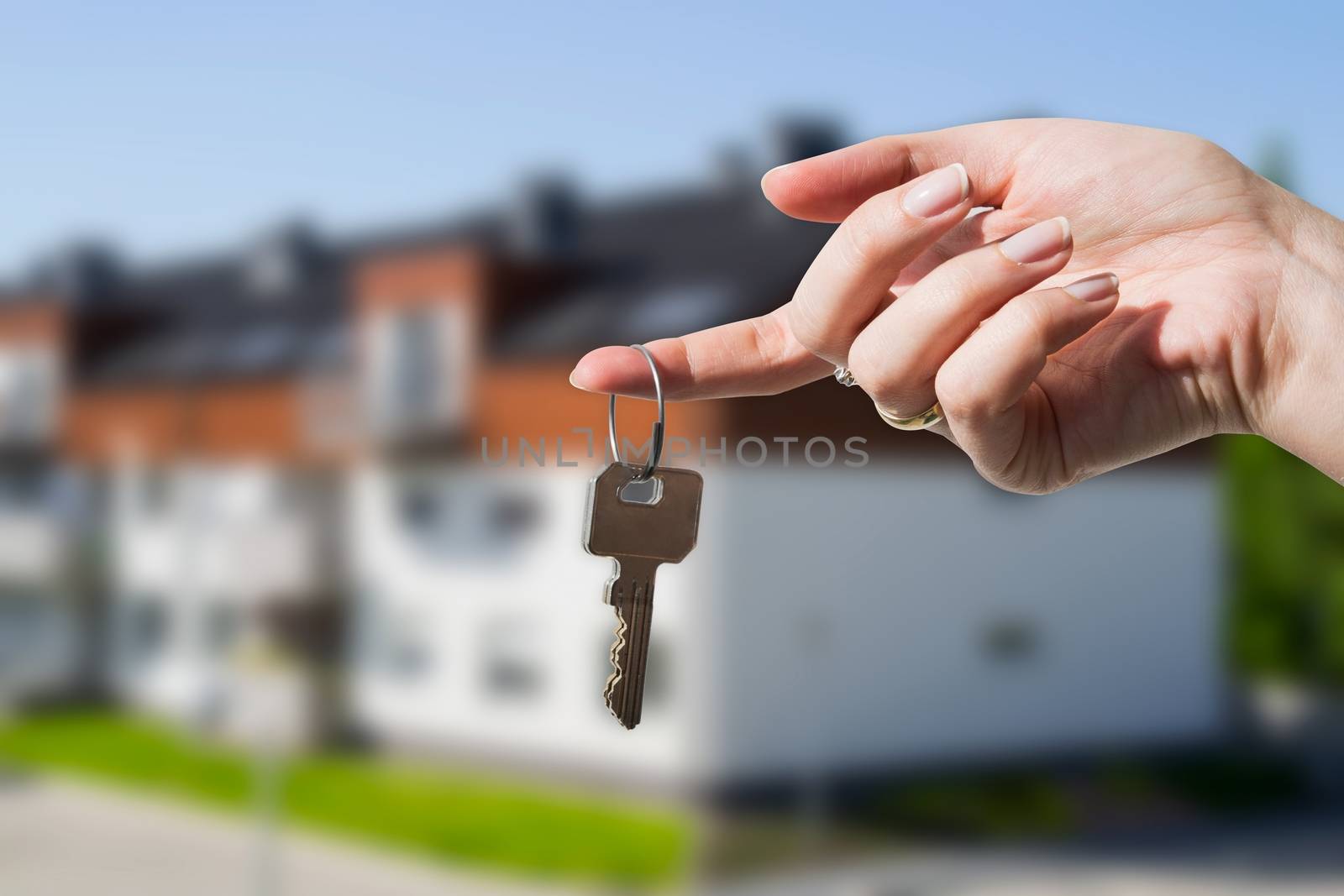 Woman's hand holding keys to new house by simpson33