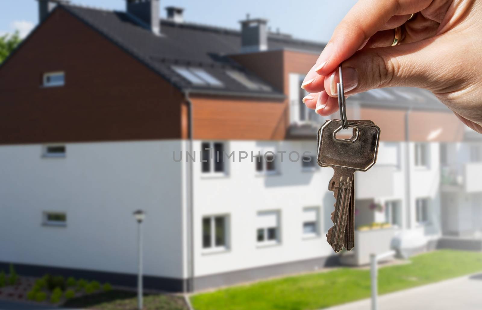 Woman's hand holding keys to new house