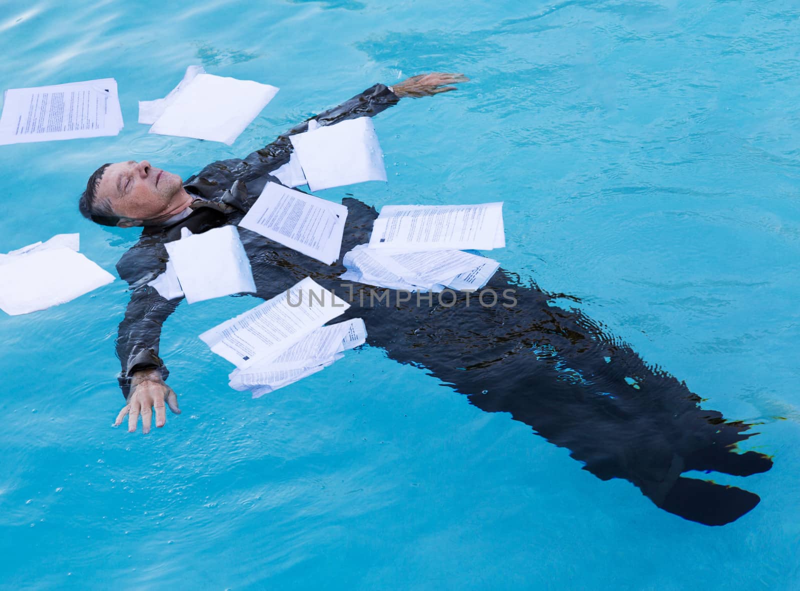 Senior man floating among papers in water by steheap