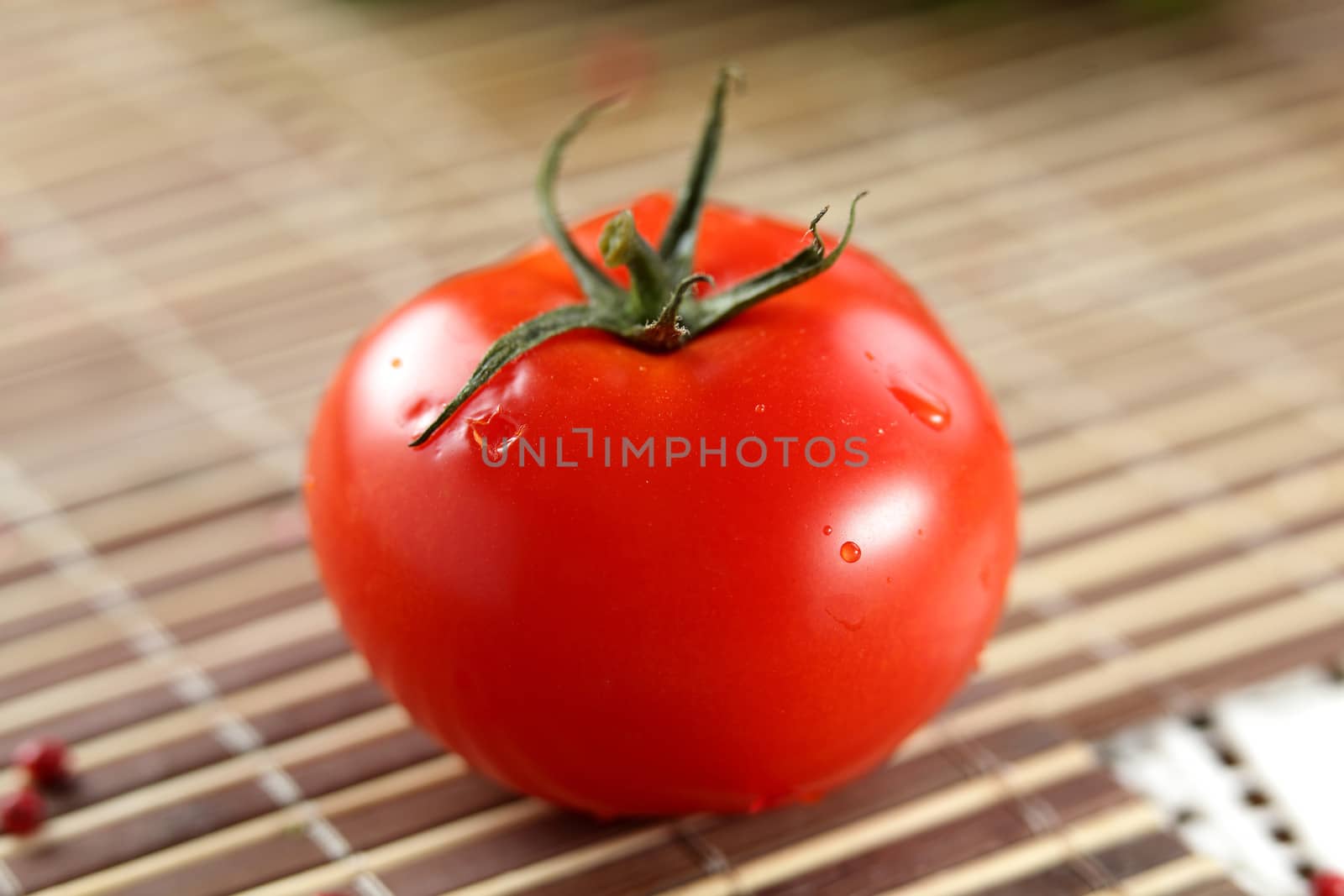 fresh red tomato on table by fiphoto