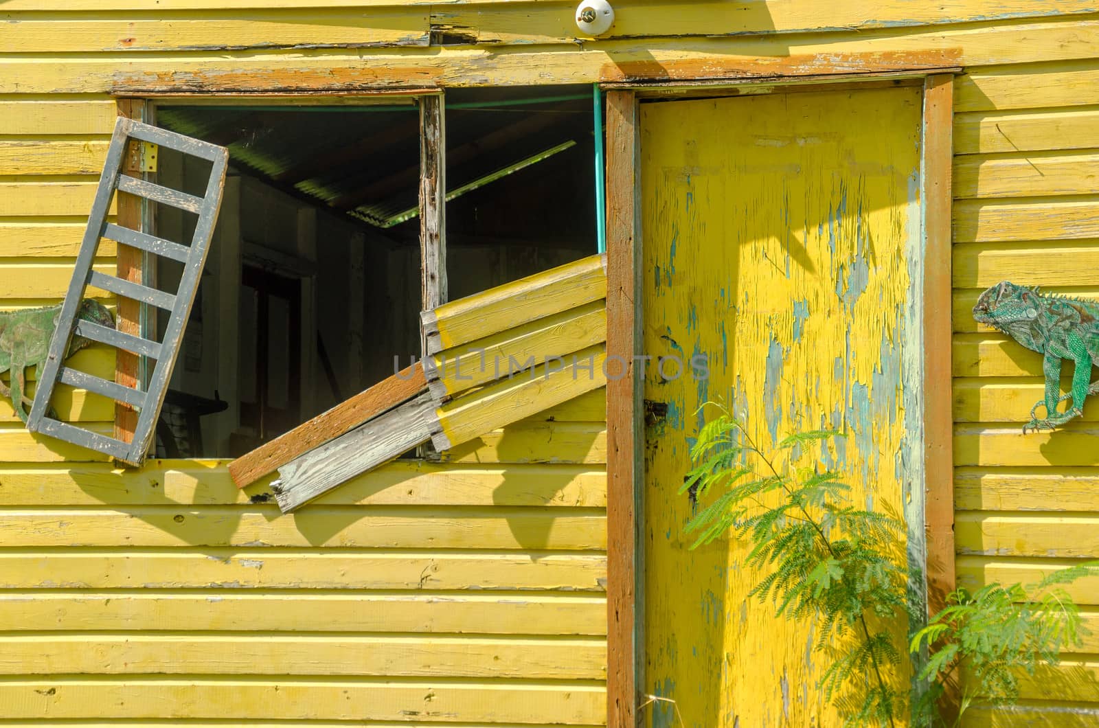 Old abandoned yellow building on tropical island of San Andres y Providencia, Colombia