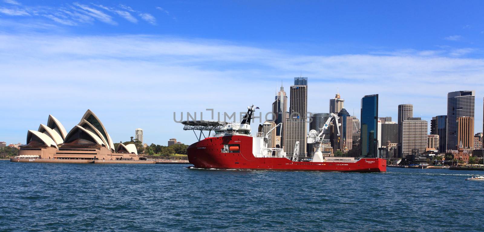 Sydney, Australia - October 6, 2013:  Navy vessel Ocean Shield, sails on Sydney Harbour past the Opera House.  Ocean Shield is used to transport troops for humanitarian and disaster relief operations.  It has a helipad.