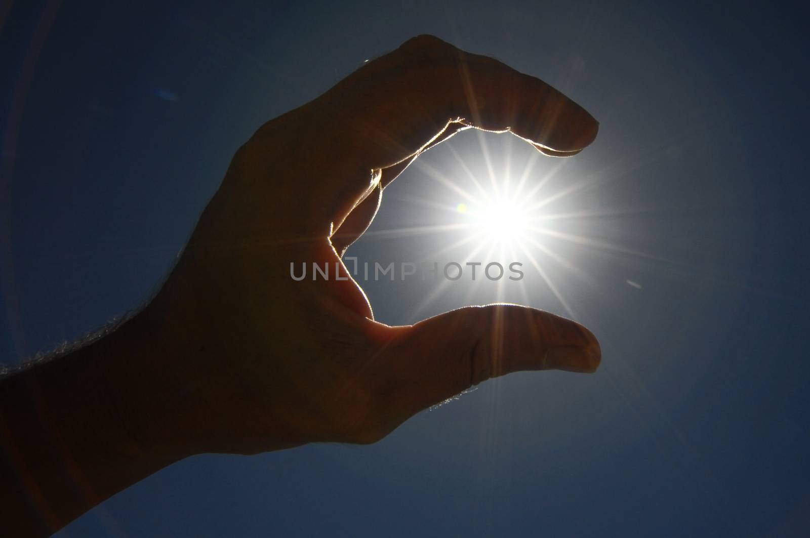 One Hand Catching the Sun Stars on a Blue Background