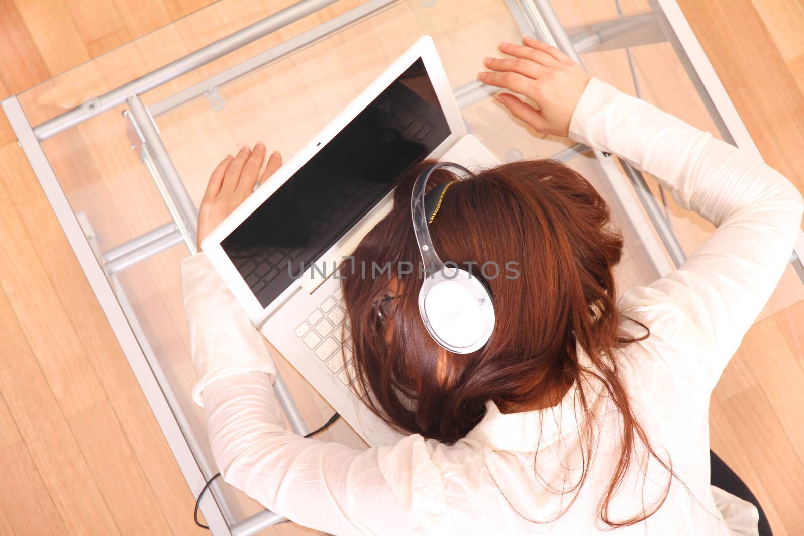 A woman sleeping on the Laptop.
