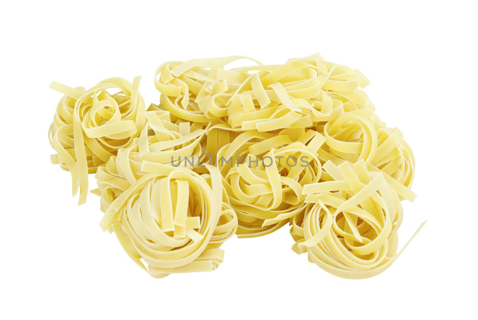 Italian pasta fettuccine nests isolated on white background with clipping path included. 