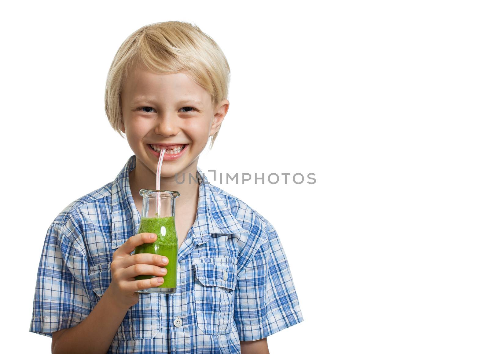 Cute young boy drinking green smoothie by Jaykayl