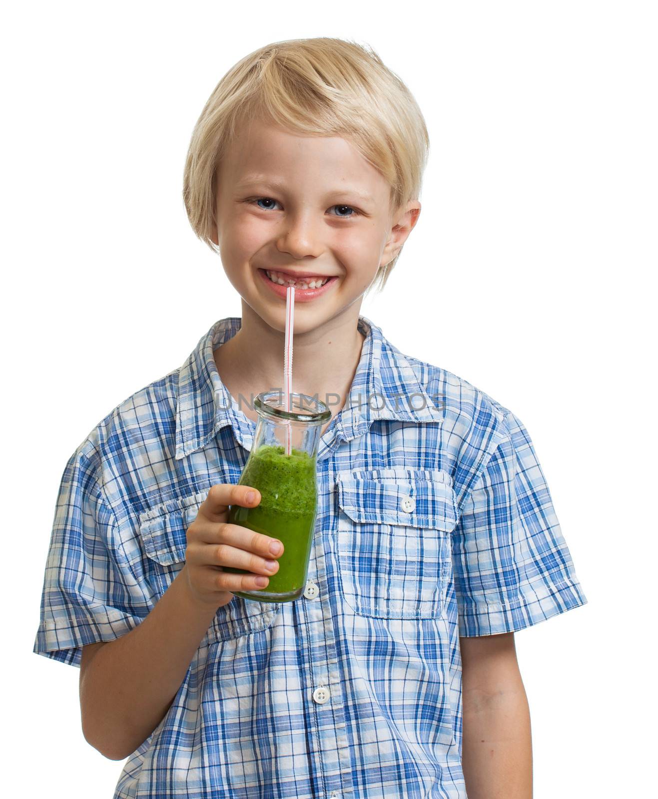 A cute young healthy boy drinking a green smoothie or jucie. Isolated on white.