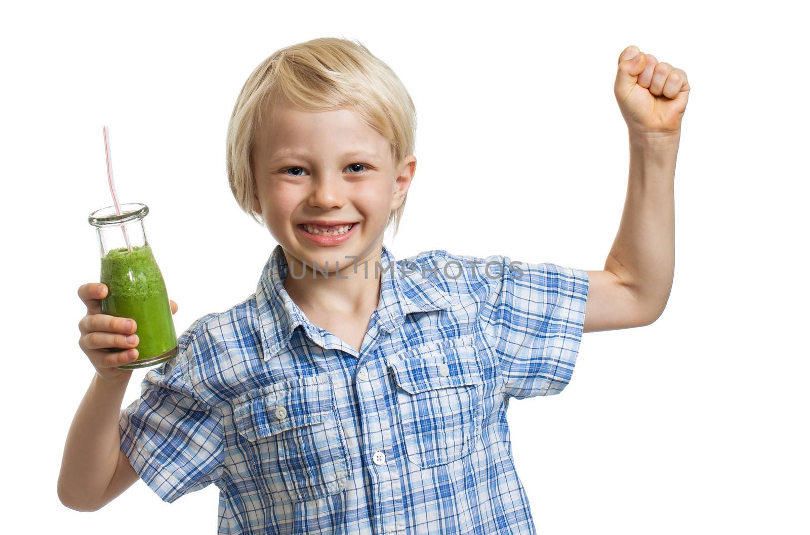 A healthy cute boy holding a green smoothie or jucie and flexing his muscles. Isolated on white.