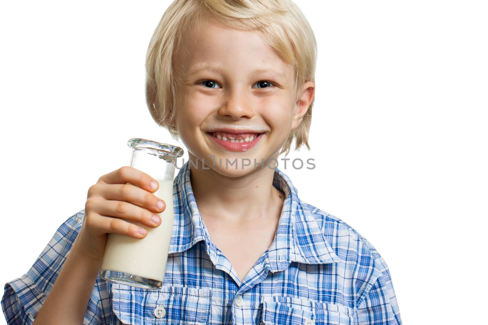 Close-up portrait of a happy cute boy with a bottle of milk and a milk moustache. Isolated on white.