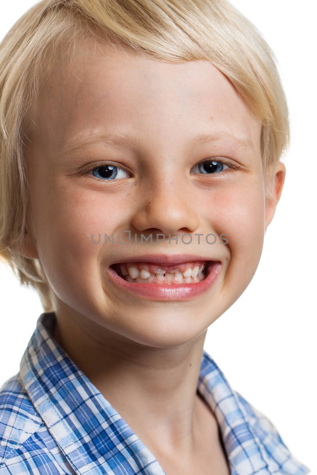 Close-up portrait of a happy cute boy with two missing front teeth. Isolated on white.