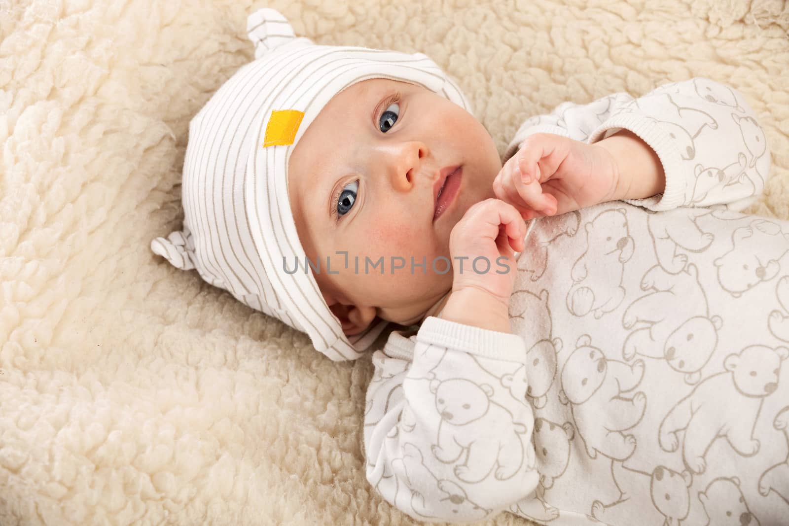 Closeup portrait of baby boyis a sheep-blanket by photobac