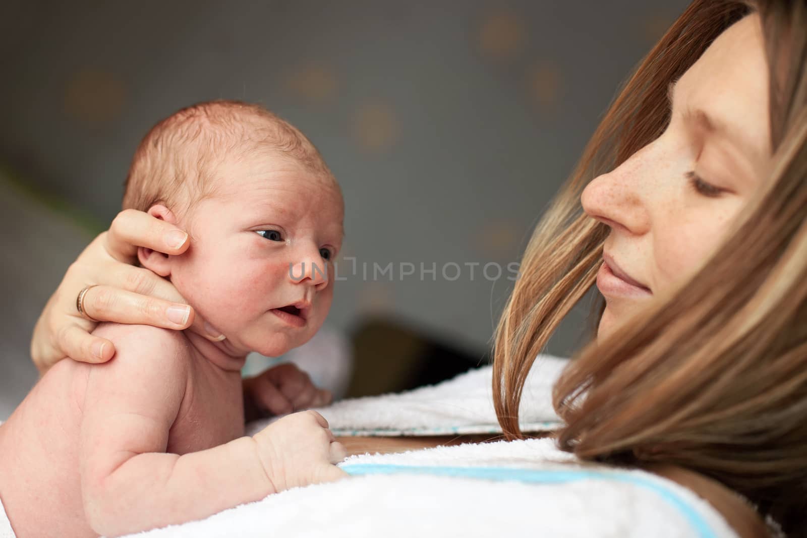 Young Caucasian mother and her newborn baby boy by photobac