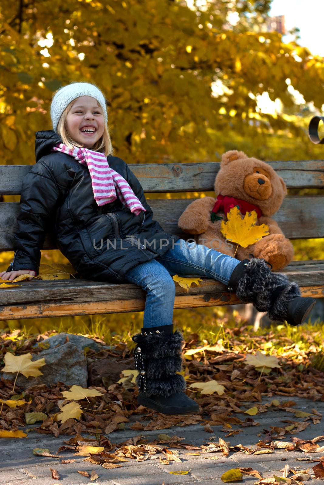 Pretty little girl relax on beauty autumn landscape background