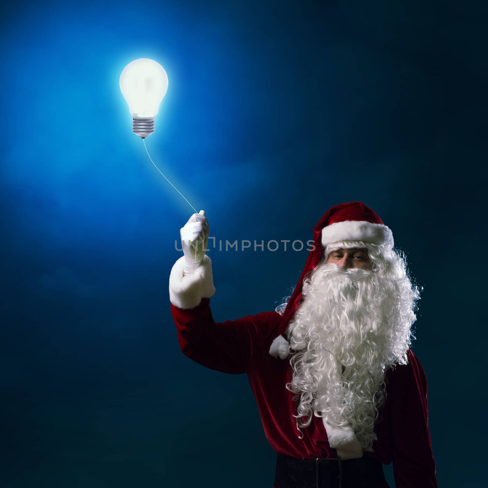 Santa Claus holding a shining light bulb for thread