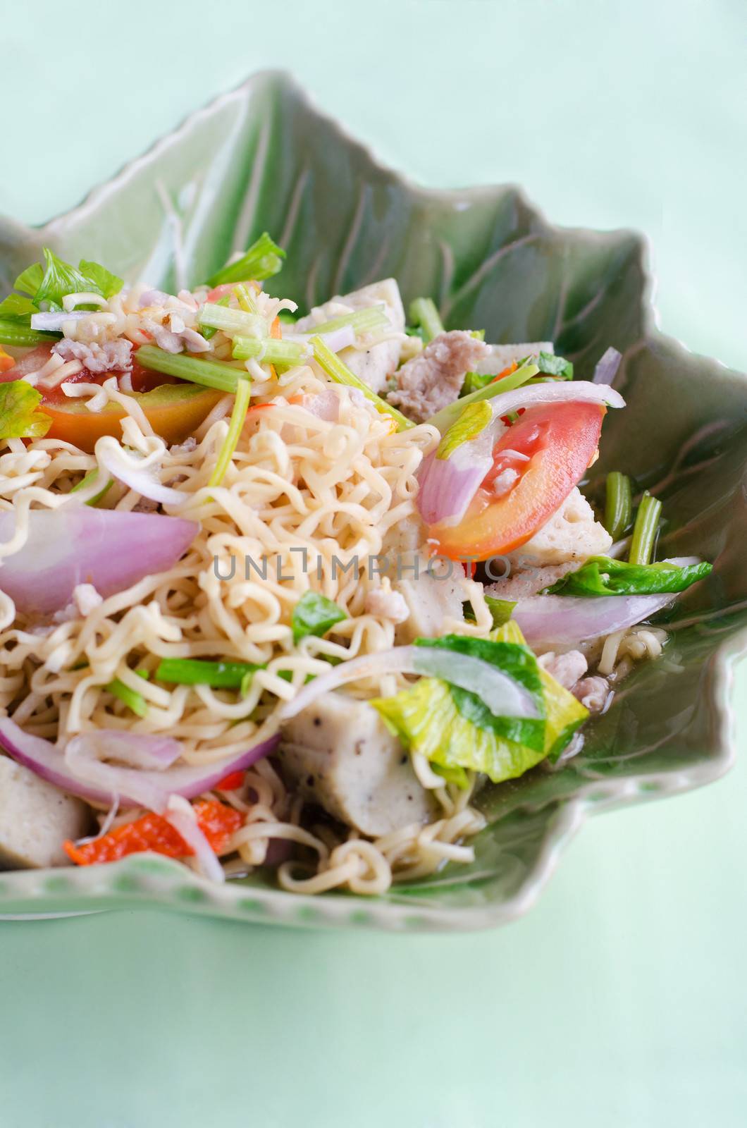 Thai dressed spicy salad with pork, tomatoes and noodle. 