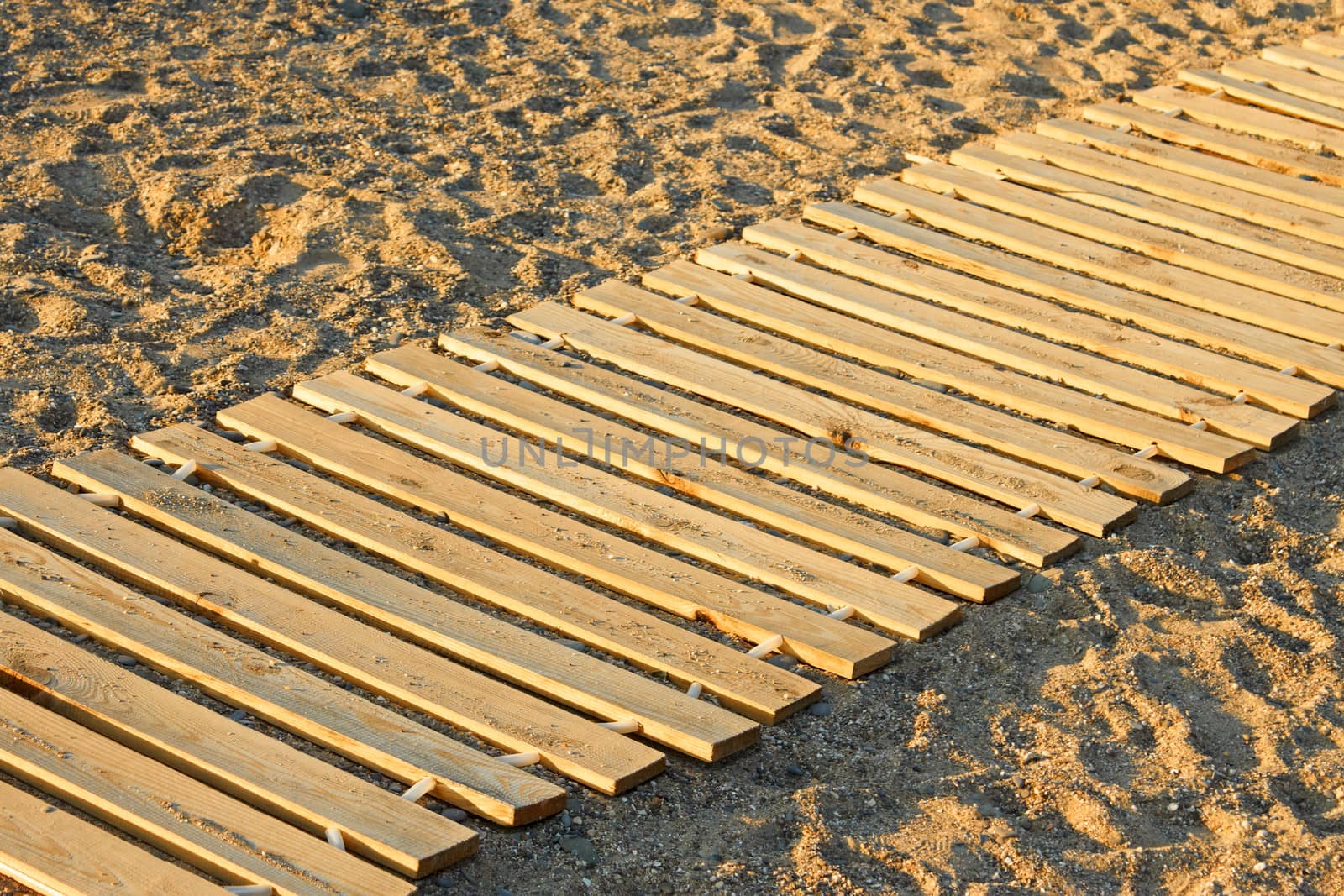 Wooden mat on a sandy beach by qiiip